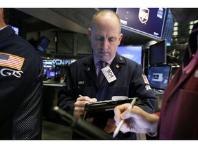 Trader Michael Urkonis works on the floor of the New York Stock Exchange, Tuesday, Feb. 5, 2019. Stocks are opening higher on Wall Street as investors welcomed some strong earnings reports from U.S. companies.