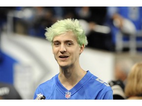 File-This Sept. 10, 2018, file photo shows Tyler "Ninja" Blevins before an NFL football game between the Detroit Lions and New York Jets in Detroit. For the first time since its meteoric rise, "Fortnite" is no longer a no-doubt victory royale atop the video game industry. "Apex Legends",  a battle royale from Electronic Arts, has stormed the market and smashed "Fortnite" records for downloads and viewership since its release three weeks ago. Blevins and other streaming stars have powered that surge, as has the emergence of an 18-year-old "Apex" superstar. Esports teams are already scrambling to sign talented players and invest long-term in the breakout title.