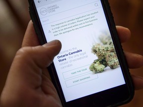 The Ontario Cannabis Store website is pictured on a mobile phone.