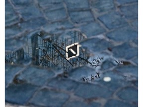 The Deutsche Bank headquarters with the bank's logo is reflected in a puddle ahead of the annual press conference in Frankfurt, Germany, Friday, Feb. 1, 2019.