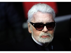 FILE - In this Thursday, Nov. 22, 2018 file photo, Fashion designer Karl Lagerfeld poses during the Champs Elysee Avenue illumination ceremony for the Christmas season, in Paris. Chanel says Tuesday, Feb. 19, 2019 its iconic couturier Karl Lagerfeld has died.