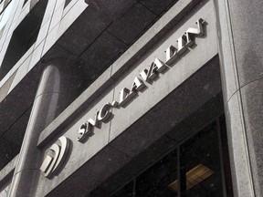 SNC-Lavalin Group cut its full-year profit forecast for the second time on Monday.