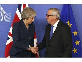 European Commission President Jean-Claude Juncker shakes hands with British Prime Minister Theresa May before their meeting at the European Commission headquarters in Brussels, Thursday, Feb. 7, 2019.