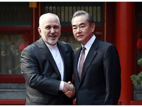 Iranian Foreign Minister Mohammad Javad Zarif, left, and his Chinese counterpart Wang Yi shake hands during their meeting at the Diaoyutai State Guesthouse in Beijing Tuesday, Feb. 19, 2019.
