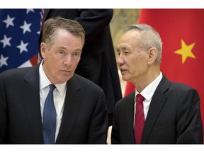 FILE - In this Feb. 15, 2019, file photo, Chinese Vice Premier Liu He, right, talks with U.S. Trade Representative Robert Lighthizer, while they line up for a group photo at the Diaoyutai State Guesthouse in Beijing. China's economy czar is going to Washington for talks Thursday and Friday aimed at ending a tariff war over Beijing's technology ambitions.