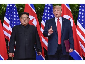 FILE - In this June 12, 2018, file photo, U.S. President Donald Trump, right, makes a statement before saying goodbye to North Korean leader Kim Jong Un after their meetings at the Capella resort on Sentosa Island in Singapore. The future of the key Yongbyon Nuclear Scientific Research Center, the heart of the North's nuclear development and research, is on the table as Kim and Trump prepare to meet in Vietnam on Feb. 27-28, 2019.