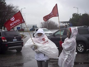 Members of Unifor, the union representing the workers of Oshawa's General Motors car assembly plant, park their cars to block the entrance to the plant, Ont., Monday Nov 26, 2018.