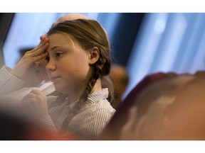 Swedish climate activist Greta Thunberg goes over her notes prior to her speech at an event at the EU Charlemagne building in Brussels, Thursday, Feb. 21, 2019. Thunberg will also participate in a climate march through the city later in the day.