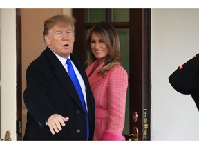 President Donald Trump with first lady Melania Trump, responds to reporters questions as he bid farewell to visiting Colombian President Ivan Duque and his wife Maria Juliana Ruiz Sandoval, outside the West Wing of the White House in Washington, Wednesday, Feb. 13, 2019.