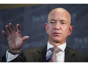 FILE- In this Sept. 13, 2018, file photo Jeff Bezos, Amazon founder and CEO, speaks at The Economic Club of Washington's Milestone Celebration in Washington. Bezos says the National Enquirer is threatening to publish nude photographs of him unless his private investigators back off the tabloid that detailed the billionaire's extramarital affair