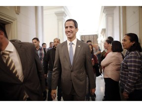 Venezuela' self proclaimed interim president Juan Guaido smiles as he arrives at the National Assembly, in Caracas, Venezuela, Wednesday, Feb. 13, 2019. Guaido said Wednesday that the National Assembly has appointed six executives to a transitional board for its PDVSA state-owned oil company and its U.S. subsidiaries, including Houston-based refiner Citgo.
