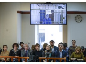 Founder of the Baring Vostok investment fund Michael Calvey is seen on a screen, with public observers and journalists below, during a court session in a court room in Moscow, Russia, Thursday, Feb. 28, 2019. Calvey, co-founder of one of Russia's oldest and biggest equity firms Baring Vostok, was arrested earlier February on suspicion of fraud.
