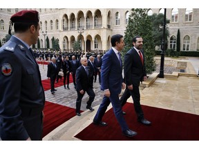 Lebanese Prime Minister Saad Hariri, right, receives his Italian counterpart Giuseppe Conte, second right, at the Government House in Beirut, Lebanon, Thursday, Feb. 7, 2019.
