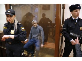 Founder of the Baring Vostok investment fund Michael Calvey sits in a cage in the court room in Moscow, Russia, Friday, Feb. 15, 2019. A veteran U.S. investment fund manager has been detained in Moscow and faces fraud charges. A Moscow court said on Friday that Michael Calvey, founder and senior partner at Baring Vostok equity firm, was detained alongside two other fund managers.