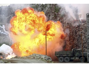 An explosion strikes during a military demonstration targeting a theatrical "ballistic missile launchpad" at the International Defense Exhibition and Conference in Abu Dhabi, United Arab Emirates, Sunday, Feb. 17, 2019. The biennial arms show in Abu Dhabi comes as the United Arab Emirates faces increasing criticism for its role in the yearlong war in Yemen.