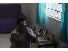 Malvina Firmina Nunes prays on her knees at home in Brumadinho, Brazil, Wednesday, Jan. 30, 2019, while one of her four adult children remains missing following a Vale dam collapsed. "Take me in his place, Lord, take me!" said Nunes. "I have already lived too much. I don't want live anymore."