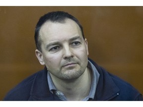 The former chief of the cybercrime department at Russia's main domestic security agency Sergei Mikhailov attends a hearing in a court in Moscow, Russia, Tuesday, Feb. 26, 2019. Moscow's District Military Court stripped Sergei Mikhailov of his colonel's rank and ordered him to pay a 400,000-ruble ($6,130) fine and handed a 14-year sentence to Ruslan Stoyanov, the former employee of Kaspersky Lab cybersecurity firm, who was charged in the same case.