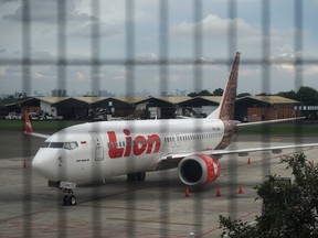 A Batik Air Boeing Co. 737 Max 8 aircraft, operated by Lion Air, center, sits on the tarmac at Soekarno-Hatta International Airport in Cenkareng, Indonesia, on Tuesday. Indonesia’s Lion Air, one of the biggest customers of Boeing’s 737 Max plane, is suspending delivery of four of the jets it had on order for this year after the second fatal accident involving the model in five months.