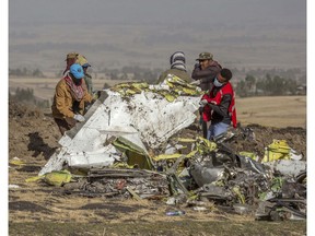 Rescuers work at the scene of an Ethiopian Airlines flight crash near Bishoftu, or Debre Zeit, south of Addis Ababa,  Ethiopia, Monday, March 11, 2019. A spokesman says Ethiopian Airlines has grounded all its Boeing 737 Max 8 aircraft as a safety precaution, following the crash of one of its planes in which 157 people were killed.