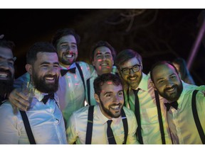 In this Feb. 16, 2019 photo, groom Juan Jose Pocaterra, center, poses for a photo with friends during his wedding party in La Llanada, a summer at the Camburito Hacienda in Acarigua, Venezuela. "Hosting a celebration amid these circumstances is obviously tough, but that's why we did the work at the hospital," said the 32-year-old co-founder and CEO of Vikua, a startup tech company whose name means "Quality of Life" and that Forbes magazine has called one of Latin America's most promising.