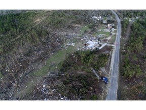 A truck, lower right, lies on its side in a neighborhood devastated by a tornado that saw multiple members of a family killed in Beauregard, Ala., Tuesday, March 5, 2019.