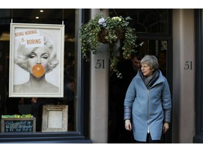 Britain's Prime Minister Theresa May  leaves Smith England hairdresser salon after a visit, in Salisbury, England, Monday, March 4, 2019, on the first anniversary of the Skripal poisoning. British authorities say they have completed the cleanup of the southwestern English city of Salisbury, where a former Russian spy was poisoned with a nerve agent.