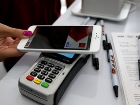 A woman uses Apple Pay at its launch in 2014.
