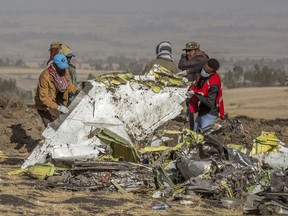 Rescuers work at the scene of an Ethiopian Airlines flight crash near Bishoftu, or Debre Zeit, south of Addis Ababa,  Ethiopia, Monday, March 11, 2019. A spokesman says Ethiopian Airlines has grounded all its Boeing 737 Max 8 aircraft as a safety precaution, following the crash of one of its planes in which 157 people were killed.