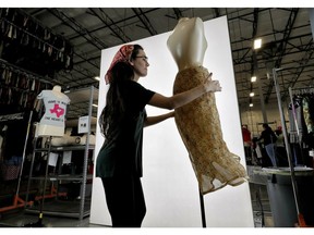 In this Tuesday, March 12, 2019, photo Samantha Estes prepares garments to be photographed at the ThredUp sorting facility in Phoenix. Charitable organizations like Goodwill have cited how Marie Kondo's popular Netflix series, "Tidying up with Marie Kondo" has led to a surge of donations. And sites like OfferUp and thredUP also note an uptick in the number of items being sent to them for sale.