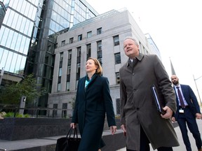Stephen Poloz, Governor of the Bank of Canada, and Senior Deputy Governor Carolyn Wilkins leave the Bank of Canada building.