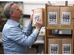 In this Monday, Feb. 25, 2019 photo, Paolo Arrigo of Seeds of Italy displays his Brexit Vegetable Growing Survival kit bags, at his company store in London. Arrigo put together 12 months' worth of easy-to-grow seed packets _ carrots, beans, lettuce, pumpkin, tomatoes _ and labelled it a Brexit Vegetable Growing Survival Kit. He has sold hundreds in a few weeks.