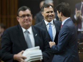 Prime Minister Justin Trudeau shakes hands with Finance Minister Bill Morneau after he tabled the federal budget in the House of Commons in Ottawa, Tuesday March 19, 2019. T