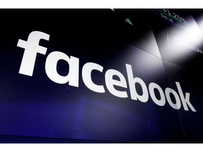 FILE - In this March 29, 2018, file photo, the logo for Facebook appears on screens in New York's Times Square.  The New York Times reports Wednesday, March 13, 2019, that federal prosecutors are conducting a criminal investigation into Facebook's data deals with major electronics manufacturers. Facebook didn't respond to a request for comment.