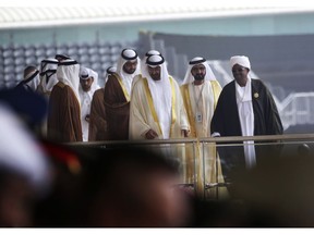 FILE - In this Feb. 19, 2017 file photo, Abu Dhabi Crown Prince Sheikh Mohammed bin Zayed Al Nahyan, third right, Dubai's ruler Sheikh Mohammed bin Rashid Al Maktoum, second right, and Sudanese President Omar al-Bashir, right, leave the International Defense Exhibition and Conference, in Abu Dhabi, United Arab Emirates. On Sunday, March 17, 2019, hundreds of Sudanese took part in anti-government protests in the capital and other cities, as the government says it has secured $300 million in loans from Emirate-based sources to address the economic crisis that triggered the unrest.