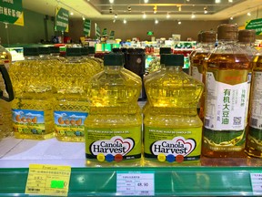 Bottles of Canola Harvest brand canola oil, manufactured by Canadian agribusiness firm Richardson International, are seen on the shelf of a grocery store in Beijing. Richardson said Tuesday that China has revoked its permit to export canola there.
