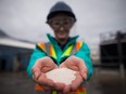 An engineer holds solid calcium carbonate pellets that were formed by precipitating captured carbon dioxide at Calgary-based Carbon Engineering's first direct air capture plant in Squamish, B.C.