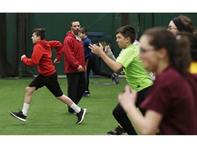 In this Wednesday, Feb. 27, 2019, photo, Anthony Sarigianopoulos trains children and young adults at the Sluggers of Ohio gym in Youngstown, Ohio. Sarigianopoulos has put in 25 years at GM's plant in Lordstown, Ohio, where the last Chevrolet Cruze will roll off the assembly line soon. Sarigianopoulos, who checks and fixes cars at the end of the line, knows he is fortunate to have a shot at a job even if it's somewhere else, unlike most of the 8,000 white-collar employees GM is laying off and those who are losing jobs at the automaker's nearby parts suppliers.