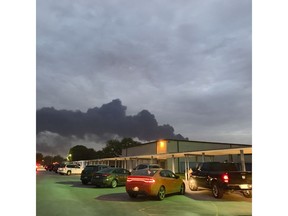 In this Tuesday, March 19, 2019 photo, shows smoke rising from a fire at the Intercontinental Terminals Company near the Carpenter Elementary School in Deer Park, Texas. Officials have lifted an order to remain indoors after several readings showed that the air quality had improved near a scorched petrochemical storage facility in suburban Houston. City officials in Deer Park lifted the order Thursday and reopened roads around the Intercontinental Terminals Company. But residents living near ITC say they're skeptical of what public officials are telling them.