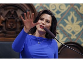 FILE - Ion this Feb. 12, 2019 file photo, Michigan Gov. Gretchen Whitmer delivers her State of the State address to a joint session of the House and Senate at the state Capitol in Lansing, Mich. Whitmer wants to spend billions more to fix the roads and boost a lagging education system. But as the Democrat prepares to deliver her first budget proposal to the Republican-led Legislature, she faces fiscal and political pressures that are complicating her task. She notes the general fund has not grown much. The budget is Whitmer's chance to detail how she plans to "fix the damn roads" and pay for priorities like letting high school graduates attend community college for free.