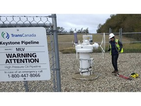 In this Oct. 11, 2016 photo provided by Samuel Jessup, climate change activist Michael Foster, of Seattle, turns an emergency shut-off valve on an oil pipeline in northeastern North Dakota. Foster was arrested and ended up spending six months in jail. The valve-turning tactic has been embraced in recent years by activists who believe fossil fuels are precipitating a global warming crisis. But the energy industry and its advocates say it amounts to domestic terrorism, and lawmakers in several states are considering stiffening penalties.