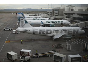 FILE - In this May 15, 2017 file photo, Frontier Airlines jetliners sit at gates at Denver International Airport. The union representing Frontier Airlines flight attendants says they have reached a tentative contract deal with the Denver-based budget carrier. The Association of Flight Attendants-CWA said both sides agreed to terms for the contract Tuesday, March 19, 2019,  but the language still needs to be finalized and approved by the flight attendants' elected union leaders. The union says the deal includes significant pay increases, schedule flexibility, quality of life enhancements and other benefits.