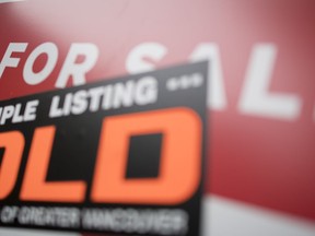 A real estate sign is pictured in Vancouver, B.C., Tuesday, June, 12, 2018. Home sales in the Greater Toronto Area in February fell compared with a year ago, while the average selling price ticked higher.