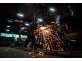 Fabricator Mike Caldarino uses a grinder on a steel stairs being manufactured for a high school in Redmond, Wash., at George Third & Son Steel Fabricators and Erectors, in Burnaby, B.C., on March 29, 2018. Statistics Canada says real gross domestic product grew 0.3 per cent in in January, topping expectations. The agency says the growth offset declines in November and December 2018.