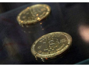 The regulatory bodies that oversee Canada's stock markets are seeking feedback on what rules should be established for new types of trading platforms for crypto currencies such as Bitcoin, Ethereum and Ripple. Physical bitcoins are displayed next to a Bitcoin ATM in Hong Kong, Friday, Dec. 8, 2017.