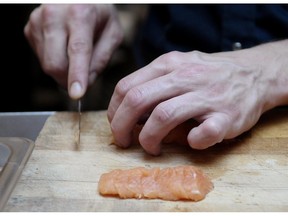 Arctic char is prepared at a restaurant in Montreal on April18 2008. Brianne Middleton once came into work 30 minutes early, changed into her chef uniform and started cutting vegetables in advance only to receive a stern talking to from her boss. Management expected her to arrive at least an hour before she clocked in to complete her prep work - all unpaid."It would be like two hours earlier or I would be in trouble," she said, adding other, more experienced chefs in that kitchen would do the same.