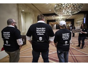 People who would be directly affected by the General Motors Oshawa plant closure stand in solidarity before Unifor National President Jerry Dias speaks during press conference asking for all Canadians and Americans to boycott all General Motors vehicles that are made in Mexico in Toronto on Friday, January 25, 2019.