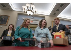 Office of Management and Budget staff delivers President Donald Trump's 2020 budget to the House Budget Committee on Capitol Hill in Washington, Monday, March 11, 2019. Trump's new budget calls for billions more for his border wall, with steep cuts in domestic programs but increases for military spending.
