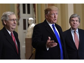 President Donald Trump accompanied by Senate Majority Leader Mitch McConnell of Ky., left, and Sen. Roy Blunt, R-Mo., right, speaks to members of the media as he arrives for a Senate Republican policy lunch on Capitol Hill in Washington, Tuesday, March 26, 2019.