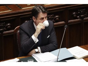 Italian Premier Giuseppe Conte drinks a coffee before addressing the Lower Chamber of the Italian parliament in Rome, Tuesday, March 19, 2019.