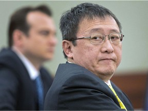 FILE - In this April 4, 2013, file photo, Hong Kong businessman Richard Suen, right, waits as counsel addresses the judge during a trial against the Las Vegas Sands Corp., in Clark County district court in Las Vegas. Jurors considering how much Suen should receive from Las Vegas Sands Corp. for help opening its first casino in Macau 15 years ago are seeing videotaped testimony from ailing billionaire Sands chief Sheldon Adelson. Attorneys for Sands argue that Richard Suen should get a fraction of the $347 million he's seeking in a long-fought breach-of-contract lawsuit.